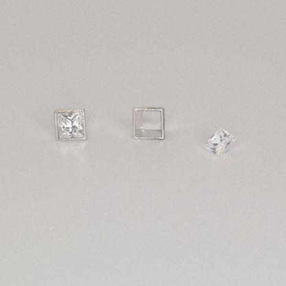 Close-up comparison of set and unset square bezel settings with princess-cut gemstones