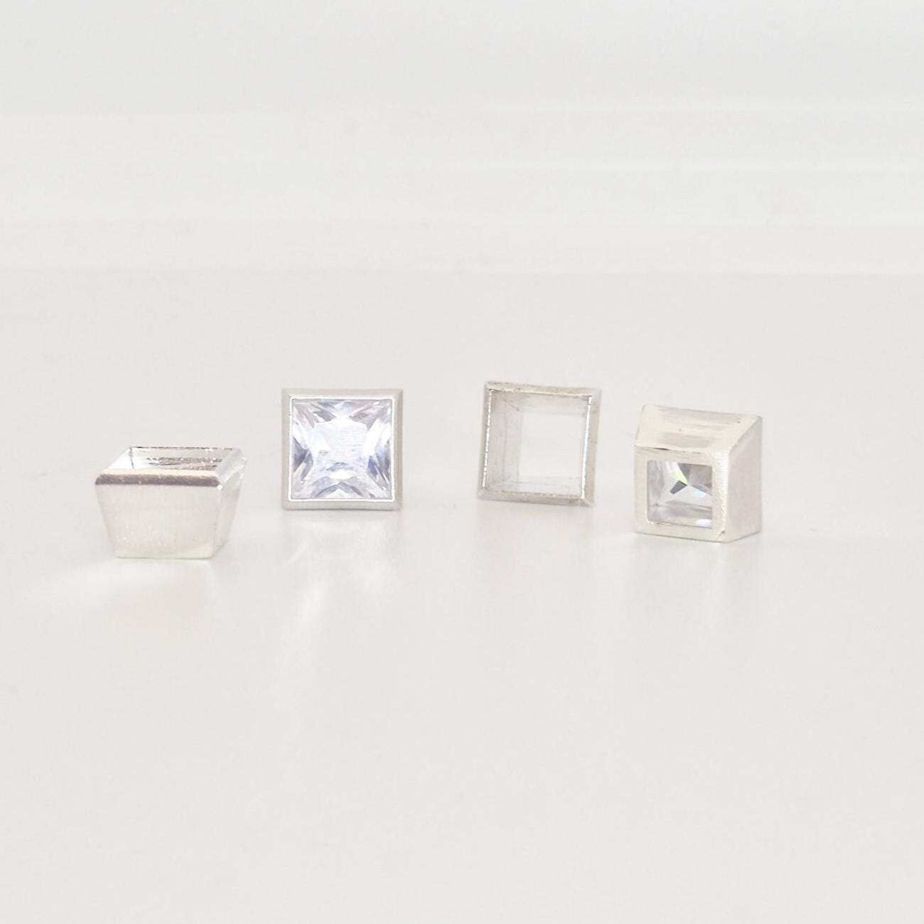 7mm bezel setting components in sterling silver with princess cut stones and open setting cups.