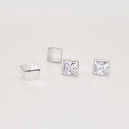 7mm square bezel setting in sterling silver with two princess cut gemstones and empty setting frame.