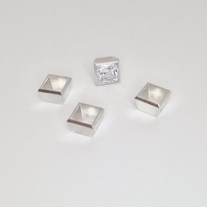 8mm square bezel setting in sterling silver with gemstone and multiple empty setting components.