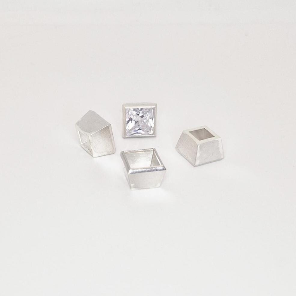 8mm bezel setting components in sterling silver arranged with princess cut gemstone.