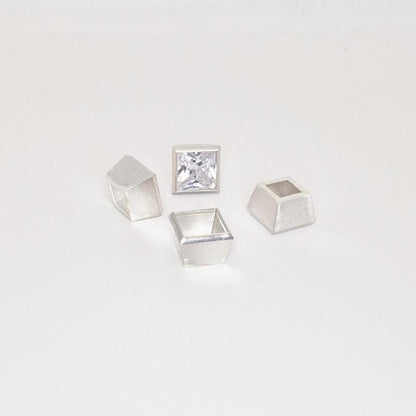 8mm bezel setting components in sterling silver arranged with princess cut gemstone.