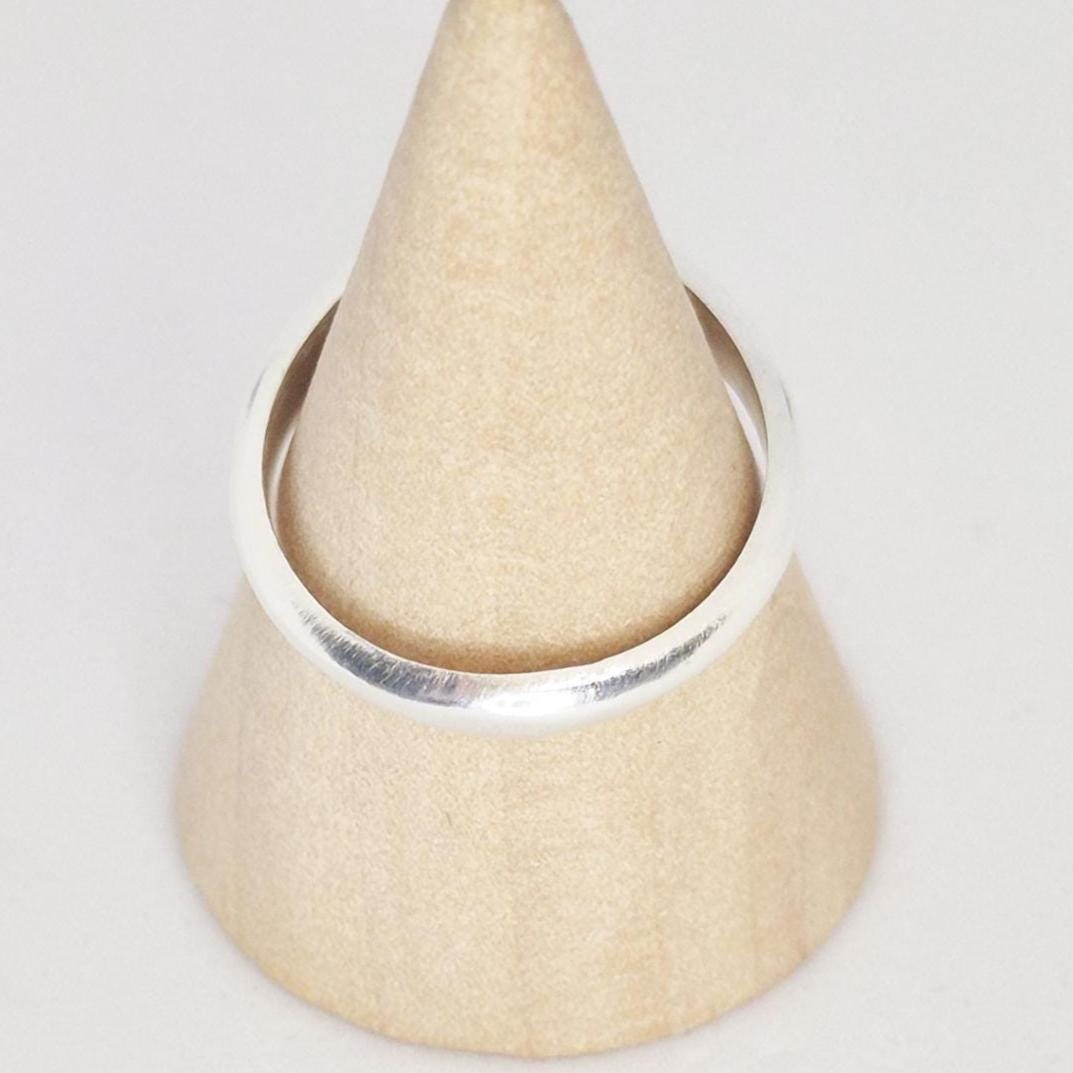 Sterling silver signet ring on cone display stand, blank round face for custom engraving