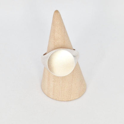 Front view of heavy silver signet ring on cone stand, 16mm blank engraving face