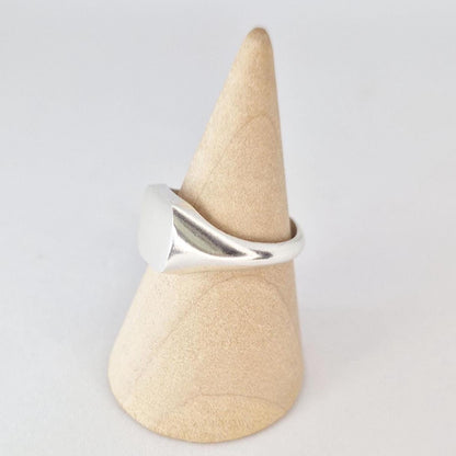 Side view of cushion signet ring in silver showing tapered shoulders and flat signet face