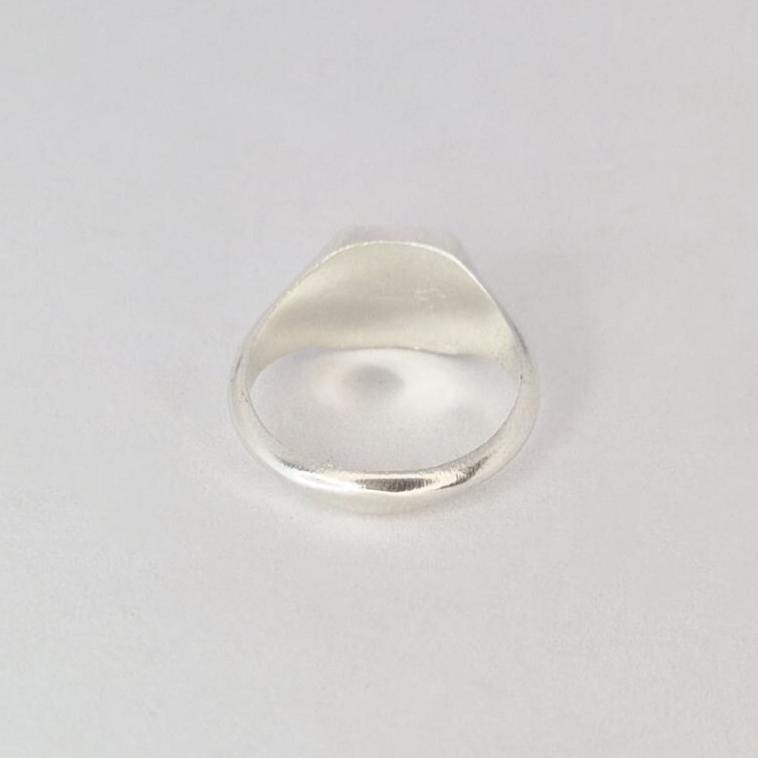 Bottom view of sterling silver signet ring showing band opening and internal finish