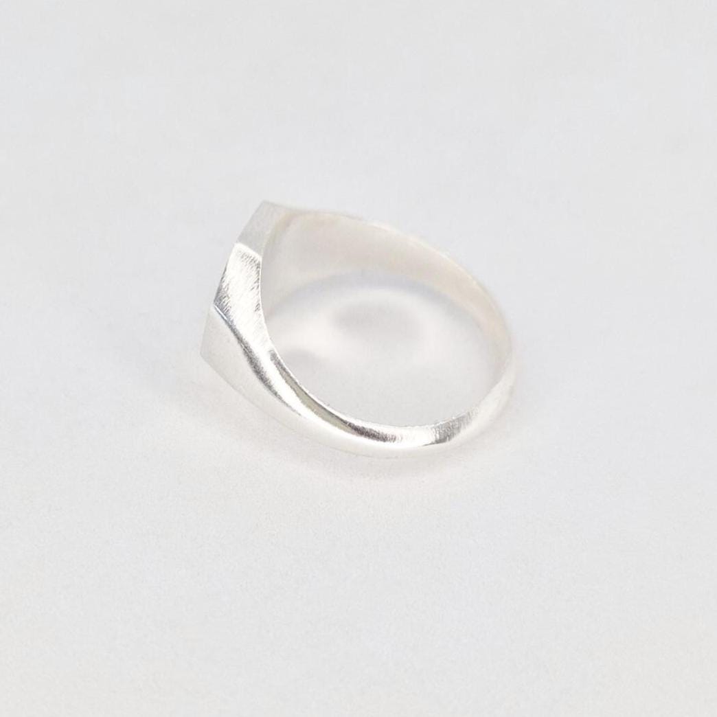 Side profile of octagon signet ring blank showing smooth tapered shank and solid construction in silver
