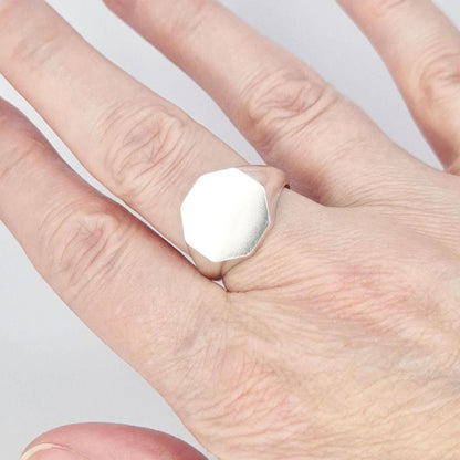 Octagon silver signet ring worn on finger, minimalist design with flat matte face