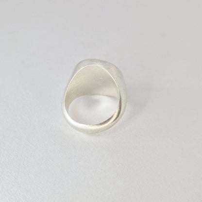 Back view of chunky signet ring showing thick band, smooth inner surface, and tapered shoulders.