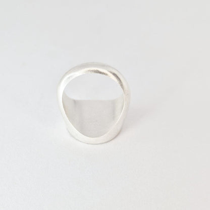 Angled rear view of signet ring highlighting band thickness and solid construction.