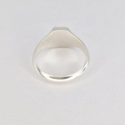 Back view of silver signet ring showing rounded band and smooth polished interior