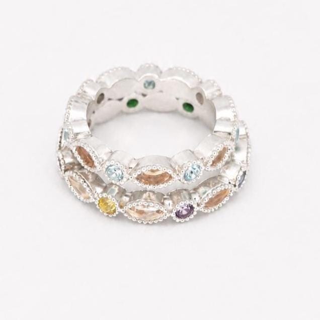 Two stacked Argentium silver birthstone rings with coloured gemstones and marquise bezel settings for memorial resin.