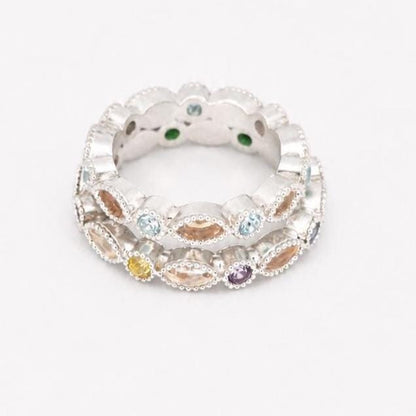 Two stacked Argentium silver birthstone rings with coloured gemstones and marquise bezel settings for memorial resin.