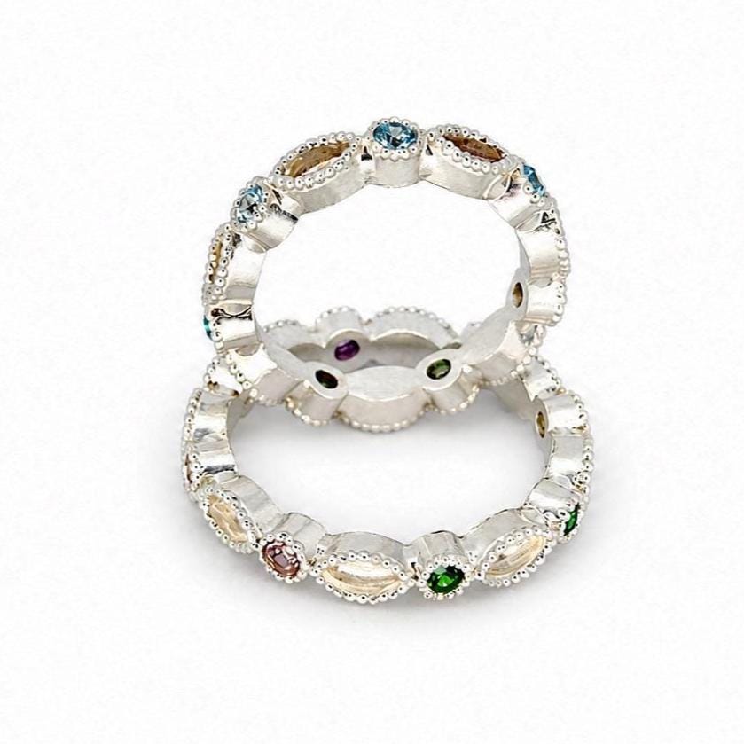 Two Argentium silver birthstone rings with coloured gemstones and marquise bezel settings for memorial resin on a white background.