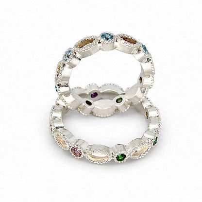 Two Argentium silver birthstone rings with coloured gemstones and marquise bezel settings for memorial resin on a white background.