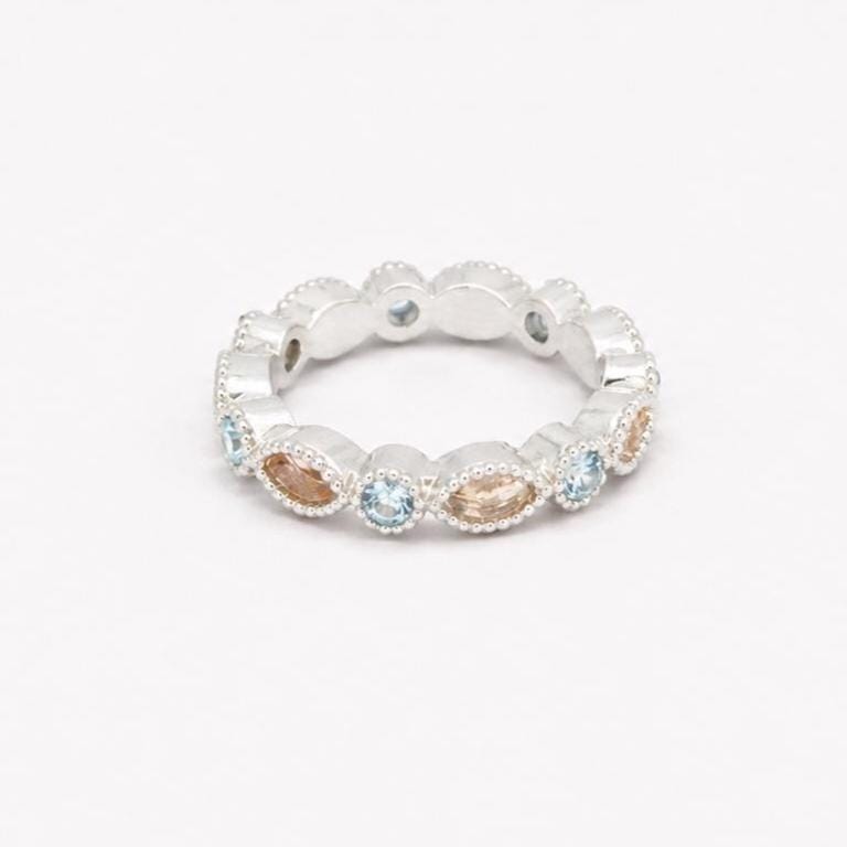 Two Argentium silver birthstone rings with aquamarine gemstones and marquise bezel settings for memorial resin.